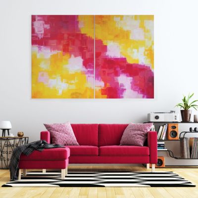 Two big paintings next to each other in different shades of red, yellow, white and pink hang on a white wall behind a red sofa in a modern living room.